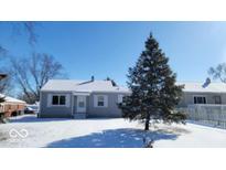 Charming home featuring new windows, gray siding, and snow-covered yard at 309 S Biltmore Ave, Indianapolis, IN 46241