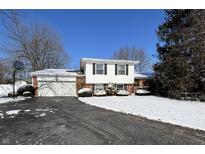 Charming two-story home featuring an attached garage and well-maintained landscaping at 6740 Live Oak Ct, Indianapolis, IN 46214