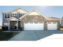 Beautiful two-story home featuring a three-car garage and stone accents at 7139 Prelude Rd, Brownsburg, IN 46112