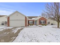 Charming single-story home with brick and vinyl siding, complemented by a well-maintained, snow-covered front lawn at 7288 Burlat Ln, Noblesville, IN 46062