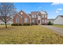 Traditional two-story brick home with a well-manicured lawn at 845 Harvest Lake Dr, Brownsburg, IN 46112