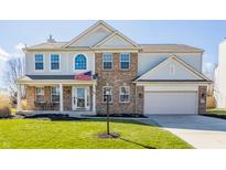 Charming two-story brick and siding home with a covered porch and well-maintained lawn on a sunny day at 89 E Bloomfield Ln, Westfield, IN 46074