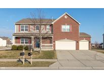 Charming two-story home boasts a brick and vinyl exterior, a cozy front porch, and a three-car garage at 1065 Kelsneland Dr, Avon, IN 46123