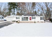 Charming single-story home with white siding, an attached garage, and a bright red front door at 1100 E Jefferson St, Franklin, IN 46131