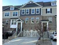 A beautiful brick townhome featuring an attached garage and concrete driveway at 16046 Coleman Dr, Westfield, IN 46074