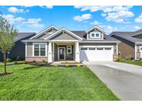 Charming single-story home with a well-manicured lawn and a two-car garage at 19726 Highclere Ln, Sheridan, IN 46069