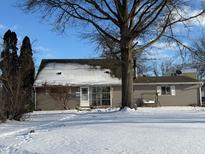 Charming single-story home with snow-covered yard and a large tree in front at 2177 Alton St, Beech Grove, IN 46107