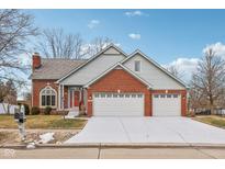 Charming brick home with gray siding, three-car garage, and a well-maintained front yard at 3226 Raylin Dr, Indianapolis, IN 46227