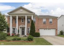 Beautiful two-story brick home boasts stately columns and a well-manicured front yard at 387 Legacy Blvd, Greenwood, IN 46143