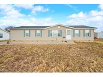 Charming single-story home with light siding, complemented by lush, green shutters at 480 Tague St, Greenfield, IN 46140