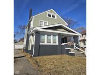 Charming two-story home with a painted brick facade and a welcoming front porch at 526 N Oxford St, Indianapolis, IN 46201
