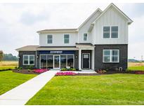 Charming two-story model home featuring a blend of white siding, brick accents, and a professionally landscaped yard at 5879 Handbell Ln, Greenwood, IN 46143