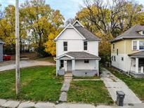 Exterior view of the house featuring a well-kept lawn, traditional architecture, and fall foliage at 638 W 30Th St, Indianapolis, IN 46208