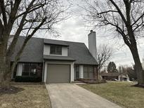 Charming home featuring a two-car garage and a classic chimney at 699 Polk St, Greenwood, IN 46143