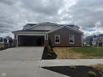Newly constructed brick home with an attached two-car garage and freshly laid landscaping at 7367 Broadview Ln, McCordsville, IN 46055