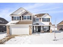 Charming two-story home featuring an attached garage, neutral siding, black shutters and a snow covered yard at 8187 Dewberry Ln, Pendleton, IN 46064