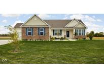 Inviting single Gathering home with brick accents, blue shutters, and a manicured lawn at 8225 W 825 N, Thorntown, IN 46071