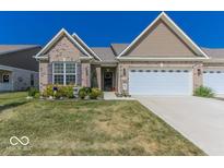 Charming single-story home with brick accents, landscaped yard, and attached two-car garage at 8724 Faulkner Dr, Indianapolis, IN 46239