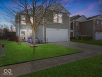 Charming two-story home featuring well-maintained lawn and attached two-car garage at 937 Balto Dr, Shelbyville, IN 46176