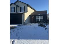 Charming two-story house with black garage door and inviting entrance, set against a clear sky at 1013 Redwood Dr, Lebanon, IN 46052