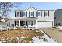 Charming two-story home featuring a covered porch and a two-car garage at 10404 Kings Gap Way, Indianapolis, IN 46234