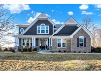 Charming two-story home with a combination of brick and siding, accented by a well-manicured lawn at 1083 Margate Dr, Greenwood, IN 46143