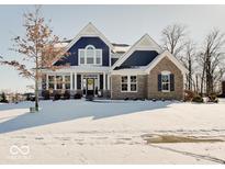 Charming home with a blue and brick facade, a welcoming front door, and a snowy front lawn at 1083 Margate Dr, Greenwood, IN 46143