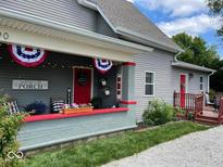 Inviting front porch with festive decorations, creating a warm and welcoming entrance to this charming home at 1390 Greenfield Ave, Noblesville, IN 46060