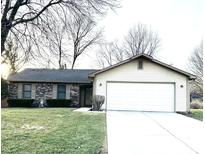 Charming single story brick home with attached two car garage and well-maintained lawn at 1818 N Girls School Rd, Indianapolis, IN 46214