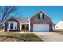 Charming brick home features a two-car garage, bay window, and well-maintained front yard at 2228 Silver Rose Dr, Avon, IN 46123