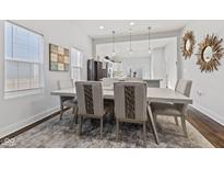 Elegant dining area featuring modern lighting and an open layout to the kitchen at 234 N State Ave, Indianapolis, IN 46201