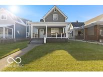Charming two-story home featuring a well-maintained lawn and inviting front porch at 234 N State Ave, Indianapolis, IN 46201