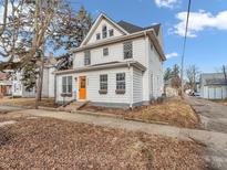 Charming two-story home featuring a bright orange door, classic architecture, and inviting curb appeal at 422 E Main St, Lebanon, IN 46052