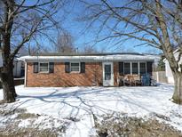 Charming brick ranch-style home with a well-maintained front yard covered in snow at 4330 Santa Fe Ct, Indianapolis, IN 46241