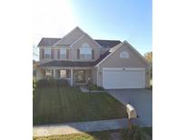 Charming two-story home with manicured front lawn and attached two-car garage at 6281 Kentstone Dr, Indianapolis, IN 46268