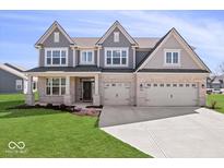 Beautiful two-story home featuring a three-car garage, light brick, grey trim, and a well-manicured lawn at 6723 Collisi Pl, Brownsburg, IN 46112