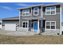 Two-story home featuring gray siding, white trim, a blue front door, and a two-car garage at 686 N Sobota Way, Trafalgar, IN 46181