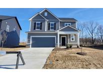 Charming two-story home with gray siding, black shutters, and a two-car garage at 6887 Seabiscuit Rd, Whitestown, IN 46075
