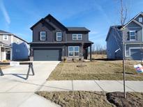 Beautiful two-story home with black siding, a well-manicured lawn, and an attached two-car garage at 6895 Seabiscuit Rd, Whitestown, IN 46075