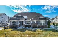 Charming single-story home featuring a well-manicured lawn and brick accents at 10590 Gardner Ct, Fortville, IN 46040