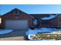 Charming single-story home featuring an attached two-car garage and manicured lawn at 1336 Country Creek Cir, Shelbyville, IN 46176