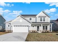 Charming two-story home with light-blue siding, attached two-car garage, and covered porch at 19763 Atwater Ave, Sheridan, IN 46069