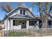Charming white two-story home with a welcoming front porch and well-maintained yard at 2162 Ringgold Ave, Indianapolis, IN 46203