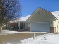 Charming single-Gathering home with a two-car garage, brick accents, and snow-covered roof at 3025 Fox Ridge Dr, Columbus, IN 47203