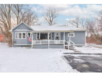 Charming one-story home featuring a welcoming front porch and a snow-covered yard at 4080 N State Road 267, Brownsburg, IN 46112