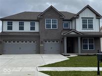 Elegant two-story home featuring a three-car garage, brick facade, and well-maintained front yard at 4187 Risen Star Way, Bargersville, IN 46106