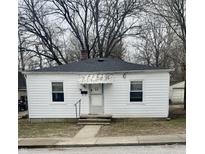 Charming white home featuring a quaint covered entryway and well-maintained front yard at 45 W Poplar St, Danville, IN 46122