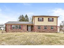 Charming two-story home featuring brick and siding with red shutters and a well-maintained front yard at 5465 Leone Dr, Indianapolis, IN 46226