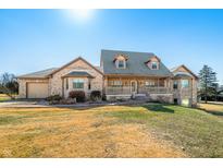 Charming brick home with a covered front porch and well-manicured lawn on a sunny day at 8221 Mcwhorter Rd, Martinsville, IN 46151