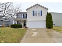 Charming two-story home featuring a two car garage, well manicured landscaping, and blue shutters at 8317 S Swimming Hole Ln, Pendleton, IN 46064